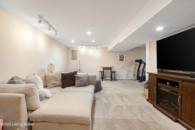 carpeted living room with track lighting and electric panel