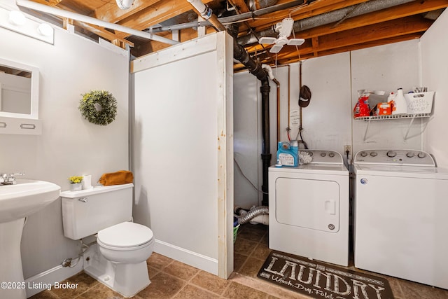 interior space with sink, tile patterned floors, and washing machine and clothes dryer