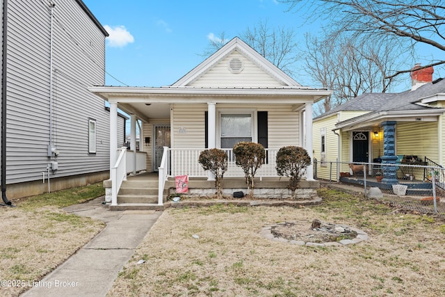 bungalow-style house with a porch and a front lawn