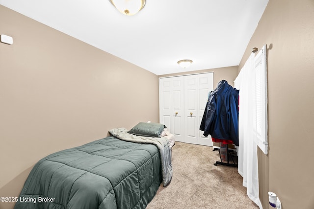 bedroom with light carpet and a closet