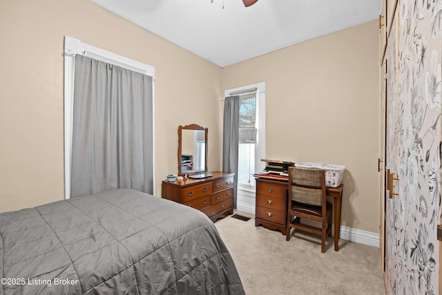 bedroom with light carpet and ceiling fan