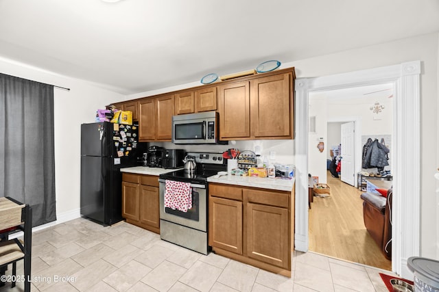 kitchen with stainless steel appliances and light tile patterned floors