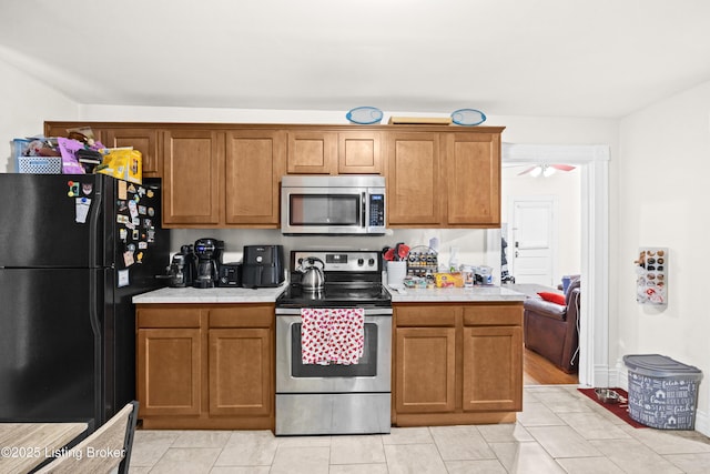 kitchen with light tile patterned floors, ceiling fan, and appliances with stainless steel finishes