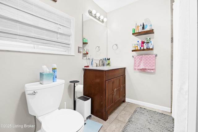 bathroom with vanity, tile patterned floors, and toilet