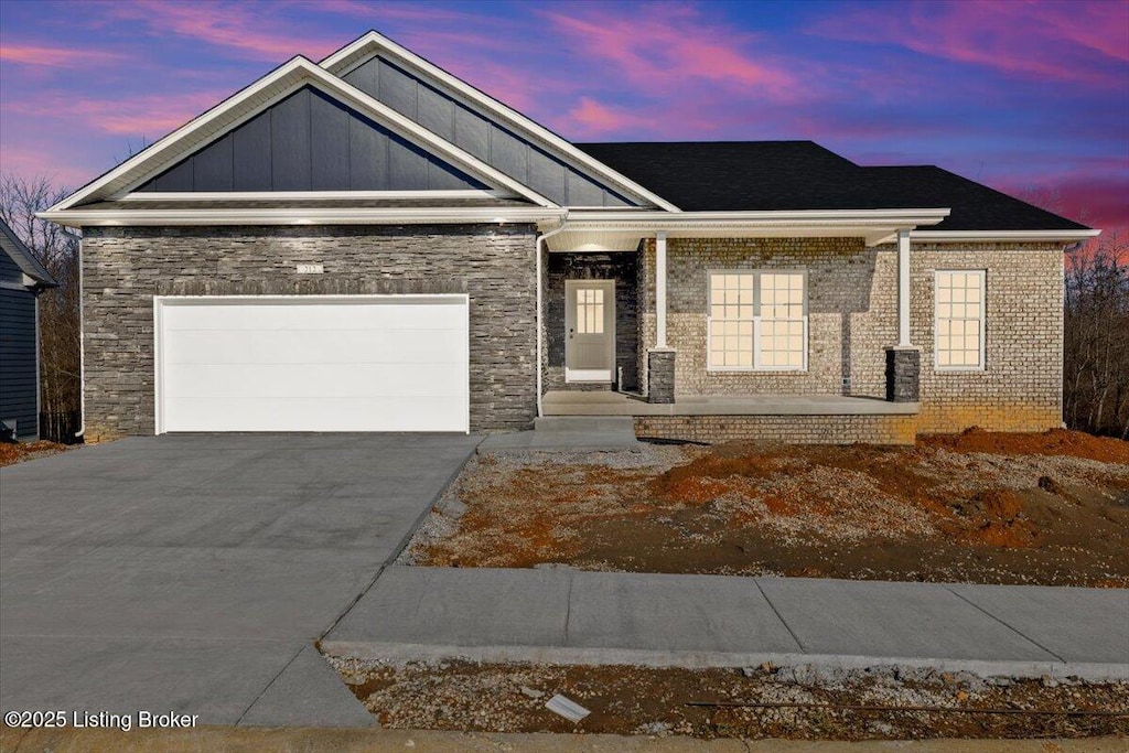 view of front facade with a garage and covered porch