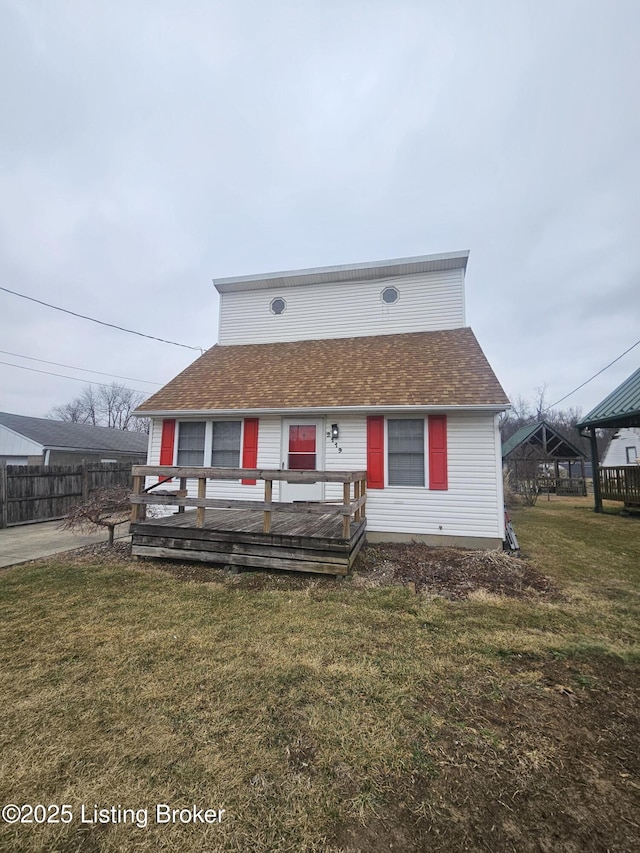 bungalow-style home with a front lawn and a deck