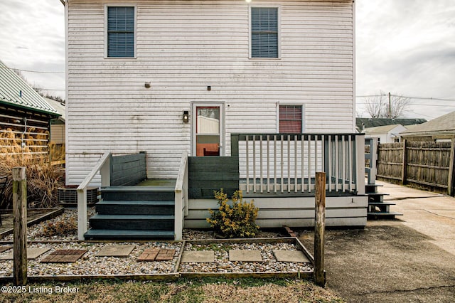 rear view of property featuring a wooden deck