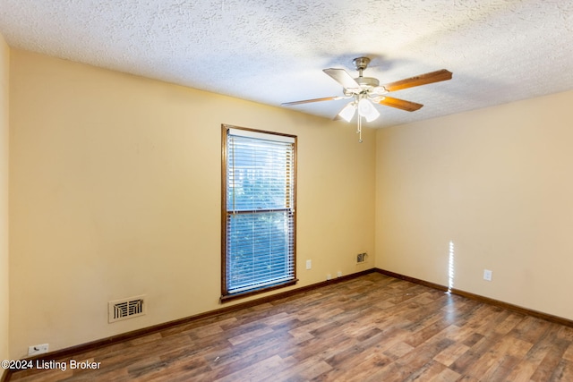 spare room featuring hardwood / wood-style flooring, ceiling fan, and a textured ceiling