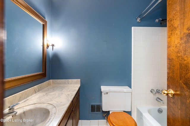 full bathroom with vanity, tiled shower / bath combo, and toilet