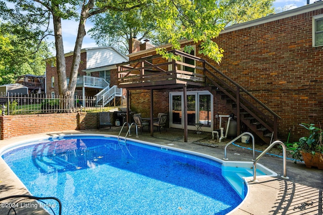 view of pool featuring a wooden deck and a patio area