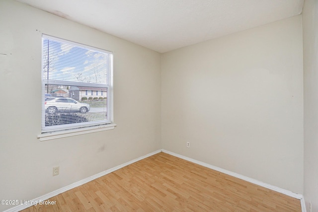 spare room with hardwood / wood-style flooring