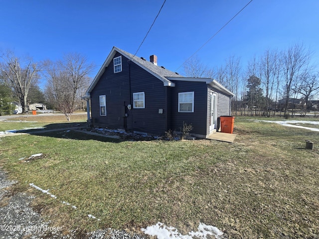 rear view of house featuring a lawn