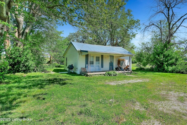 105 Sherman St, Millwood, KY 42762 - view of front of house with a porch, a front yard, and metal roof
