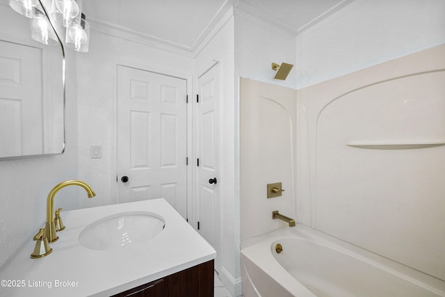 bathroom featuring vanity, ornamental molding, and bathing tub / shower combination