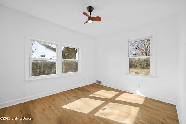 empty room featuring ceiling fan and light wood-type flooring