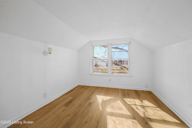 additional living space with lofted ceiling and light wood-type flooring