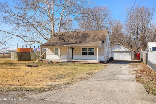 bungalow-style home with cooling unit, a garage, covered porch, an outbuilding, and a front lawn