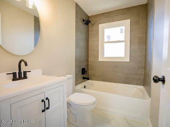 full bathroom featuring vanity, toilet, and tiled shower / bath