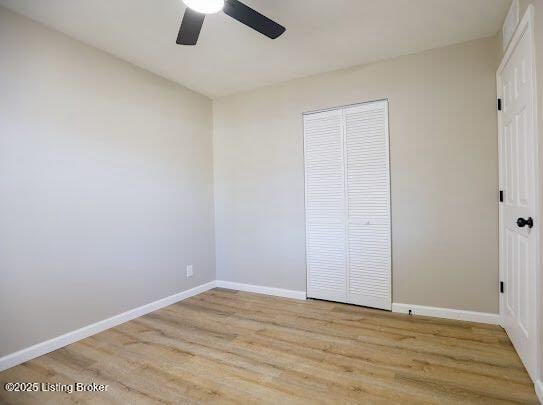 unfurnished bedroom featuring light hardwood / wood-style floors, a closet, and ceiling fan