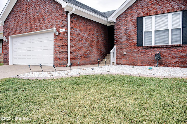 view of side of home with a lawn and a garage