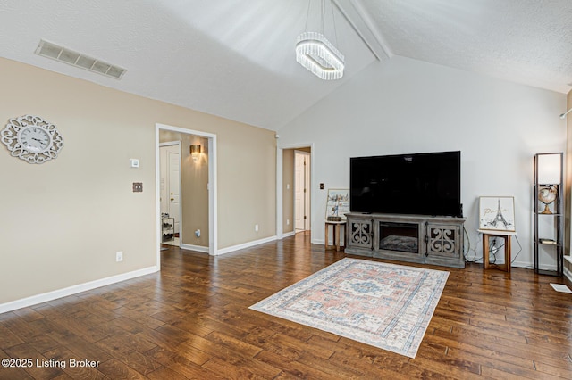 living room featuring beamed ceiling, high vaulted ceiling, dark hardwood / wood-style floors, and a textured ceiling