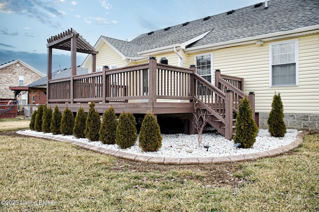 back of property featuring a yard and a wooden deck