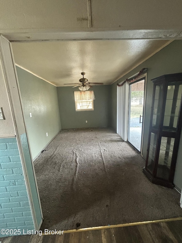 unfurnished room with ceiling fan, a textured ceiling, and a healthy amount of sunlight