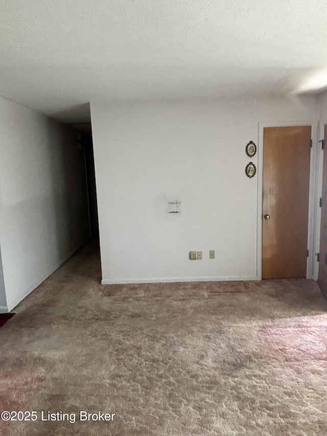 spare room with carpet flooring and a textured ceiling