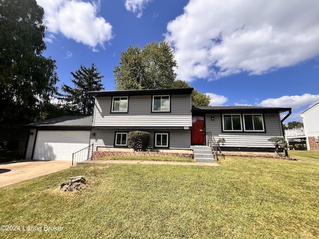 split level home featuring a garage and a front yard