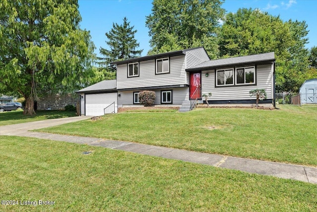 split level home with a garage and a front lawn