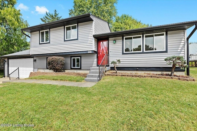 tri-level home with a garage and a front lawn