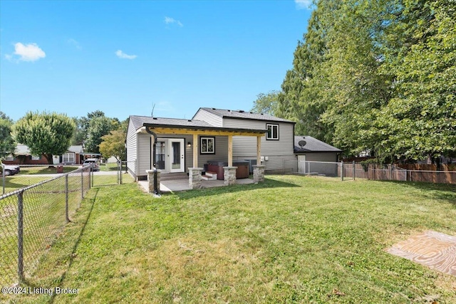 back of property featuring a lawn and a patio area