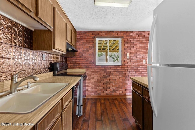 kitchen with dark wood-type flooring, black electric range oven, sink, a textured ceiling, and white refrigerator