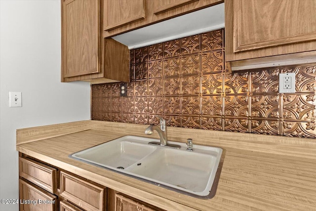 kitchen featuring tasteful backsplash and sink