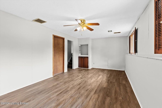 interior space featuring ceiling fan, hardwood / wood-style floors, and a textured ceiling