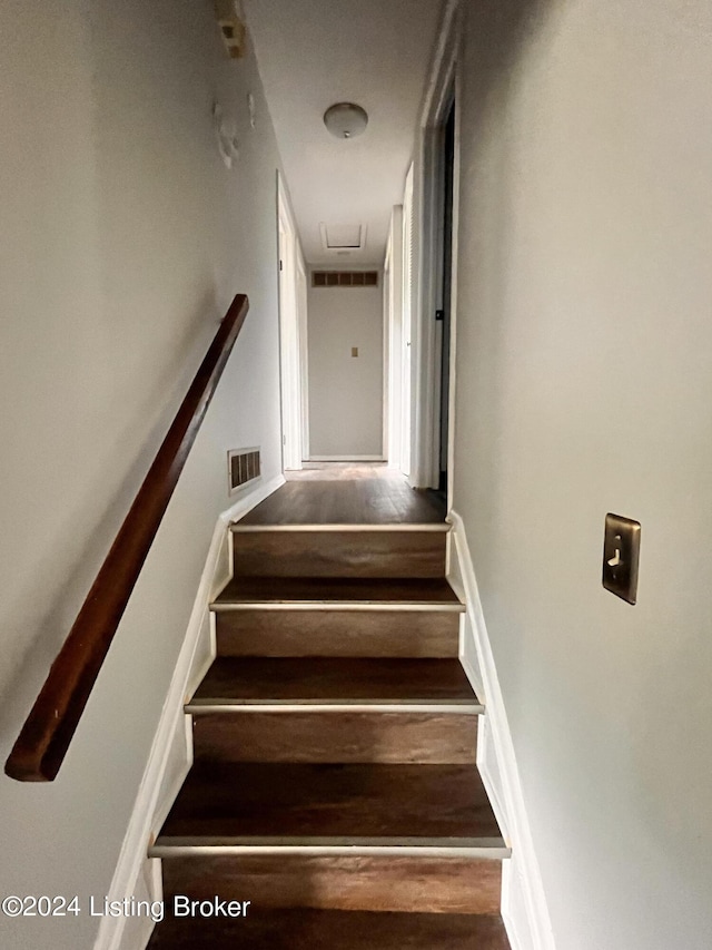 stairs featuring wood-type flooring