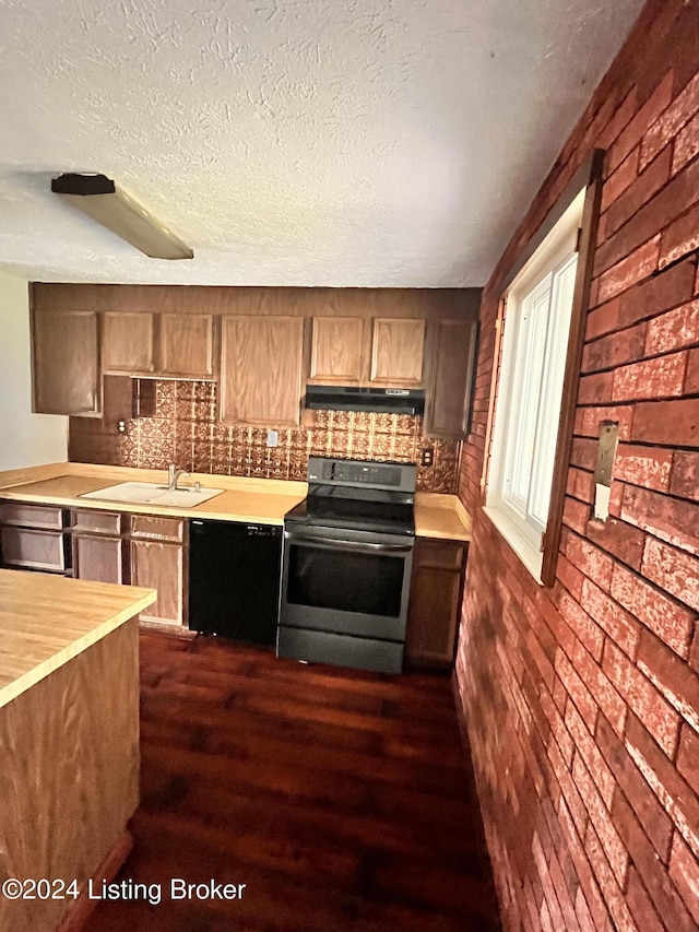 kitchen with stainless steel electric stove, black dishwasher, sink, and a textured ceiling