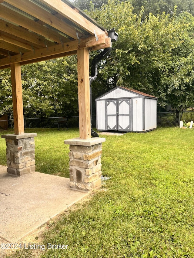 view of yard featuring a patio area and a storage shed