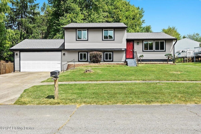 split level home featuring a garage and a front yard