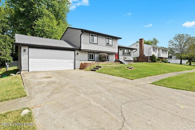 view of front of home featuring a garage and a front yard