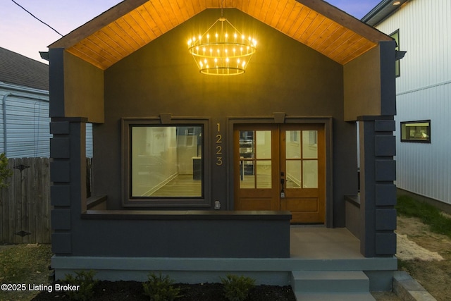 exterior entry at dusk featuring french doors