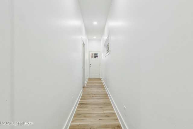 corridor with light hardwood / wood-style flooring