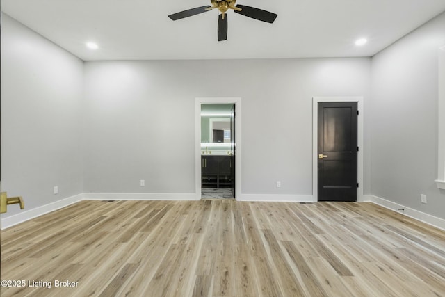 spare room featuring ceiling fan and light wood-type flooring