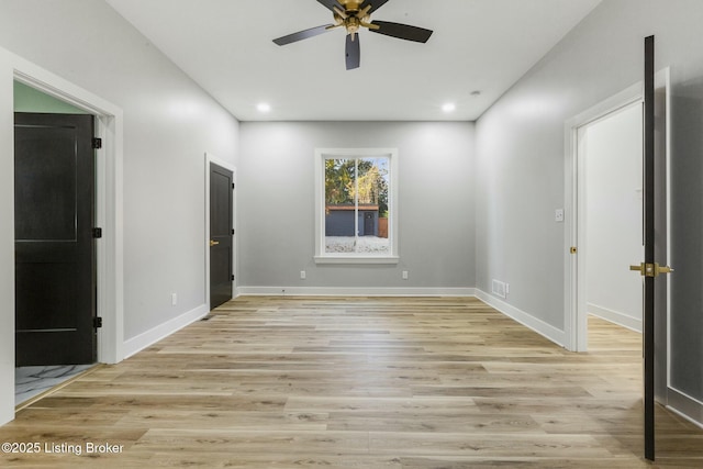 empty room with light hardwood / wood-style flooring and ceiling fan