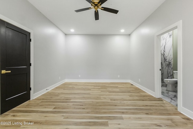 empty room featuring ceiling fan and light wood-type flooring