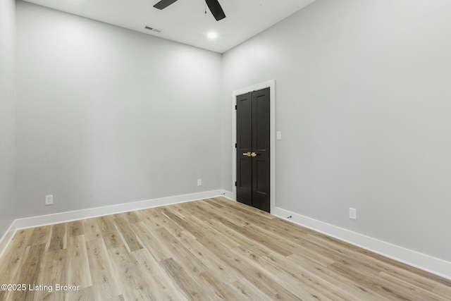 spare room featuring ceiling fan and light hardwood / wood-style flooring