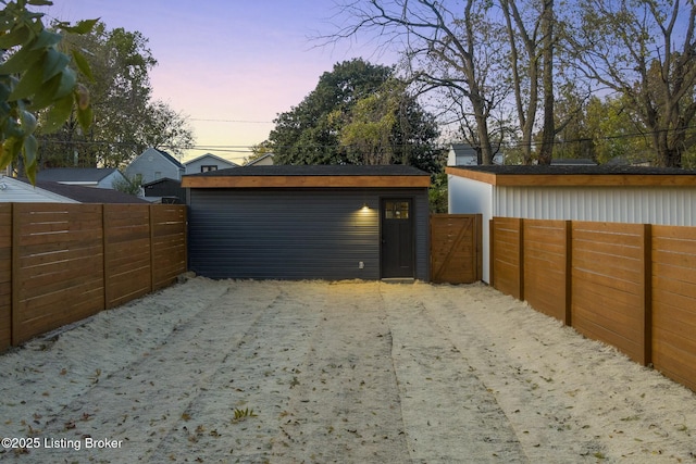 view of garage at dusk