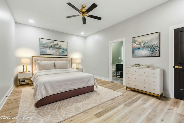 bedroom featuring ceiling fan, ensuite bathroom, and light wood-type flooring