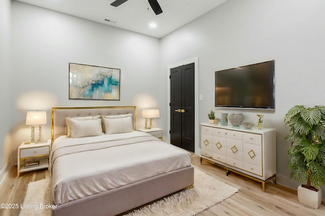 bedroom with ceiling fan and light wood-type flooring