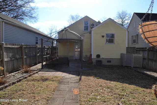 rear view of house with a yard and a patio area